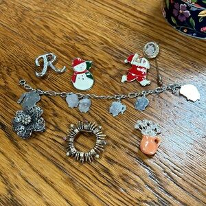 Assorted costume jewelry.  Includes 8 pieces. Seven pins and 1 bracelet.